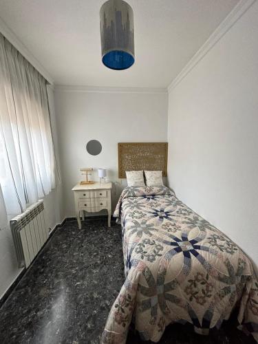 a bedroom with a bed and a table and a blue light at Casa Emilio in Pulianas