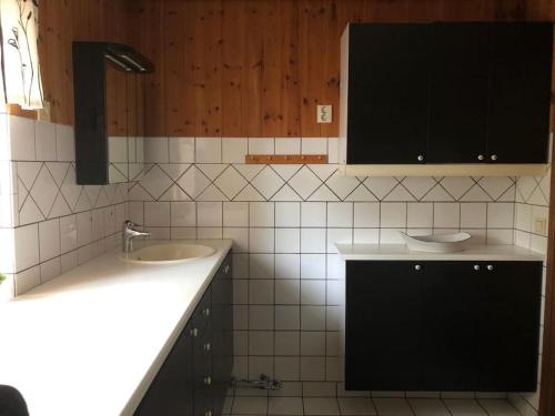 a bathroom with two sinks and black cabinets at Barts house 