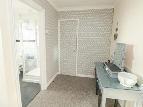 a bathroom with a sink and a toilet in a room at The White House in Torquay