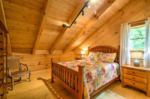 a bedroom with a bed in a log cabin at Scenic Trade Cabin with Deck Near Boone and App State! in Trade