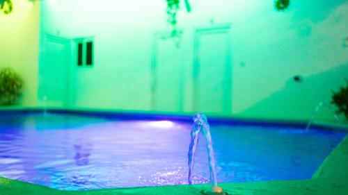 a swimming pool in a house with a door at Hotel Villas Lucciana in El Paredón Buena Vista