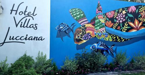 a sign for the hotel villas las vegas with a picture of a butterfly at Hotel Villas Lucciana in El Paredón Buena Vista