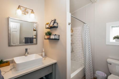 a bathroom with a sink and a mirror at Renovated Bungalow Getaway in Philomath
