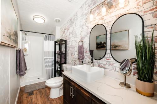 a bathroom with a sink and two mirrors at Renovated Bungalow Getaway in Philomath