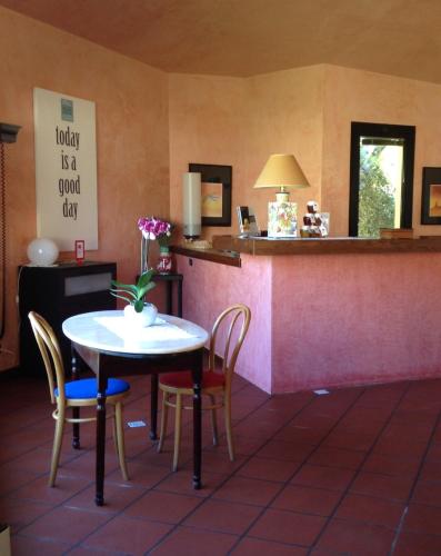 a dining room with a table and chairs and a counter at AliaJazz Hotel in Castrovillari