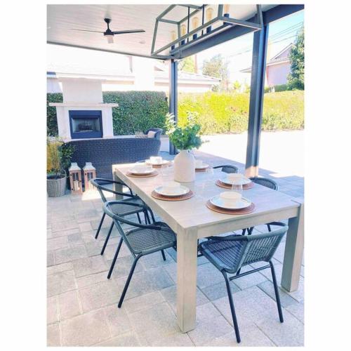 a table and chairs sitting on a patio at Private Pool Oasis/Disney 15mins /Disney+ HBO/Gym in Placentia