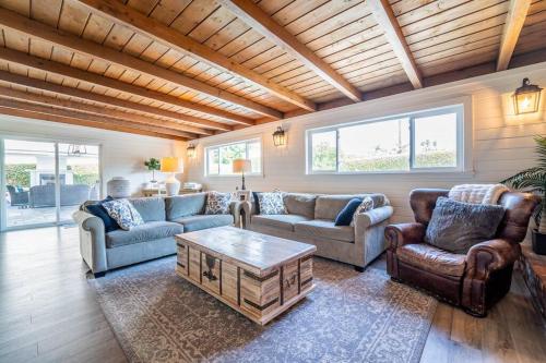 a living room with couches and a coffee table at Private Pool Oasis/Disney 15mins /Disney+ HBO/Gym in Placentia