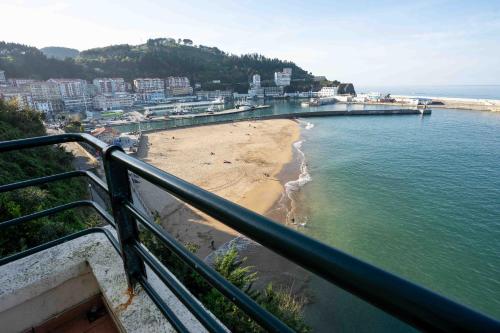 a view of a beach from a balcony at Arrigorri Ostatu Jatetxea in Ondárroa