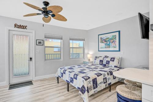 a bedroom with a bed and a ceiling fan at Sea Rocket 21 in St. Pete Beach