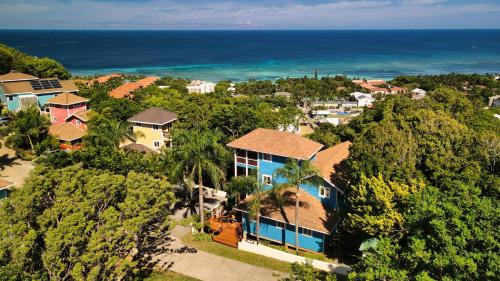 an aerial view of a house with the ocean in the background at Incredible Ocean Views From Both Sides Of This Hill Top Home, in West Bay