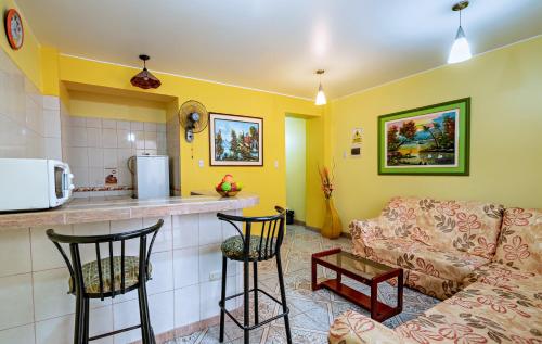 a living room with a couch and a kitchen at Hotel Costa Norte in Chiclayo