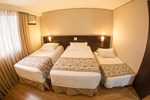 Ein Bett oder Betten in einem Zimmer der Unterkunft Hotel Campo Largo Comfort
