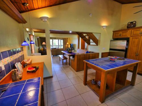 a kitchen and living room with a table in it at Incredible Ocean Views From Both Sides Of This Hill Top Home, in West Bay