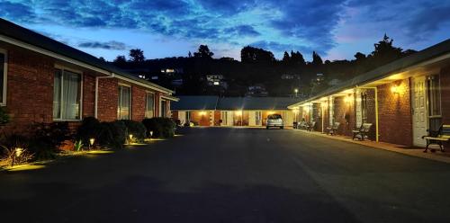 an empty street at night next to buildings at ASURE Ambassador Motor Lodge in Oamaru