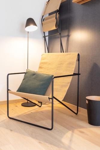 a bed frame with a pillow and a lamp at Gyger Restaurant Confiserie B&B in Thusis