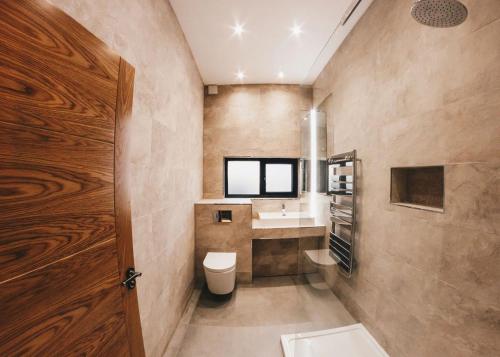 a bathroom with a toilet and a sink at Goosedale Lodges in Nottingham
