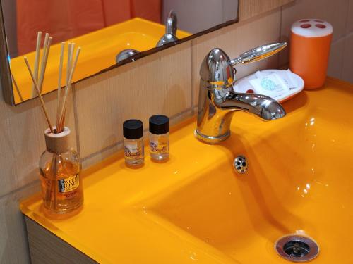 a yellow bathroom sink with a yellow sink at Menelaou Cozy Apartment in Athens
