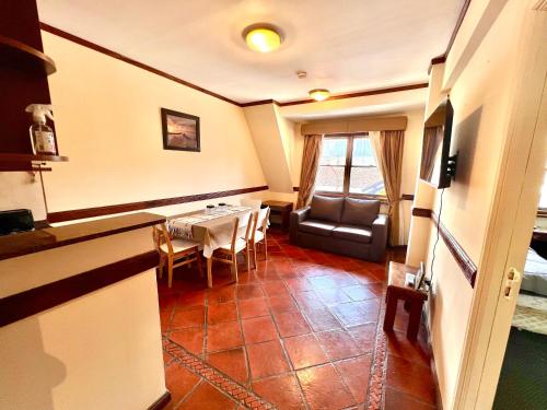 a living room with a table and a couch at Viejo lobo 203 in Ushuaia