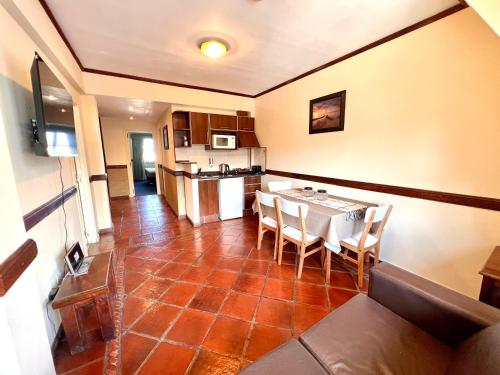 a kitchen and dining room with a table and chairs at Viejo lobo 203 in Ushuaia
