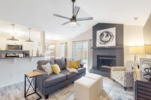 a living room with a couch and a fireplace at OZK Trail House in Bentonville