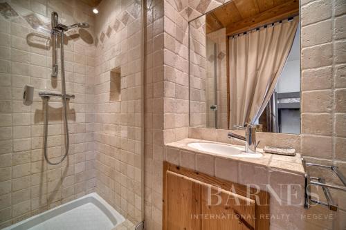 a bathroom with a shower and a sink and a tub at Apartments in Chalet Nessa in Combloux