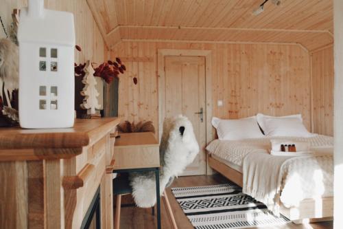 Un dormitorio con una cama y una mesa con un animal de peluche en Cuib din Fagaras, en Avrig