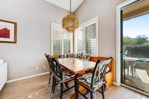 a dining room with a table and chairs and a window at Roy Rogers Poolhouse in Cave Creek