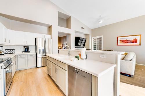 a kitchen with white cabinets and a white counter top at Roy Rogers Poolhouse in Cave Creek