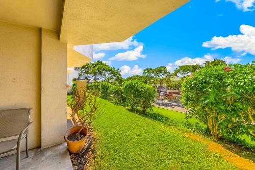 a balcony with a view of a green yard at Greens At Waikoloa J101 in Waikoloa Village