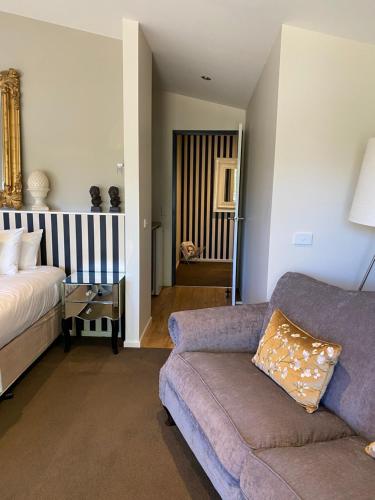 a living room with a couch and a bed at Adelphi Apartments 3 or 3A - Downstairs 2 Bedroom or Upstairs King Studio with Balcony in Echuca