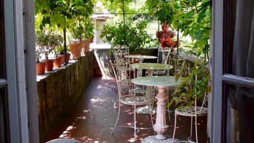 a patio area with chairs, tables, and umbrellas at Locanda Sant' Agostino in Lucca