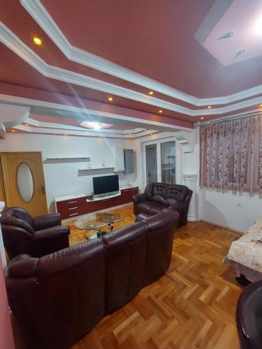a living room with leather furniture and a table at Petreski Apartments 1 in Ohrid