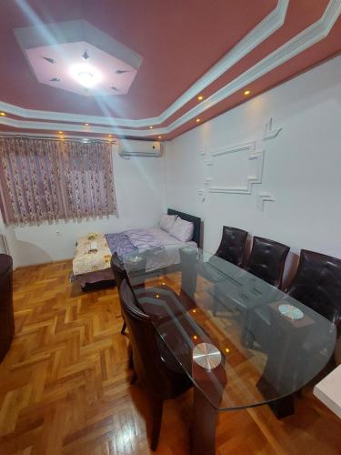 a dining room with a glass table and chairs at Petreski Apartments 1 in Ohrid