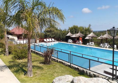 a large swimming pool with a fence around it at Altos del Sol - Spa & Resort in Merlo