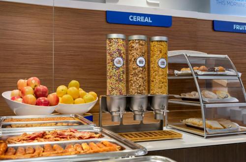 a buffet with different types of food on display at Holiday Inn Express Vancouver-Metrotown (Burnaby) in Burnaby