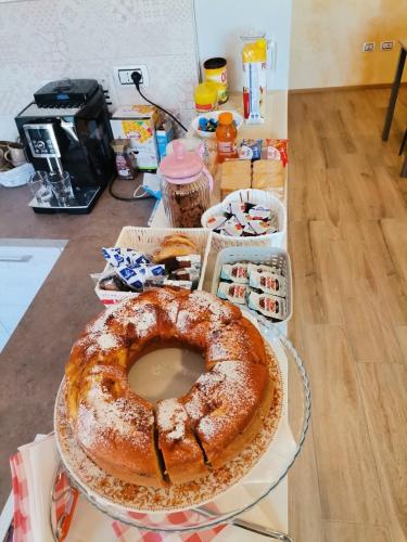 a bundt cake sitting on a counter with a table at B&B Butterfly in Bresimo