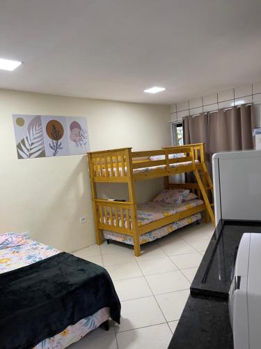 a bedroom with two bunk beds in a room at BERTIOGA suítes na praia centro in Bertioga
