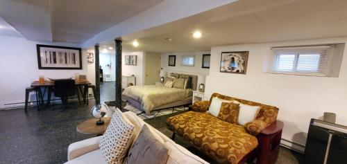 a living room with a couch and a bed at Cozy Studio; Lower Level Unit in Laurelton