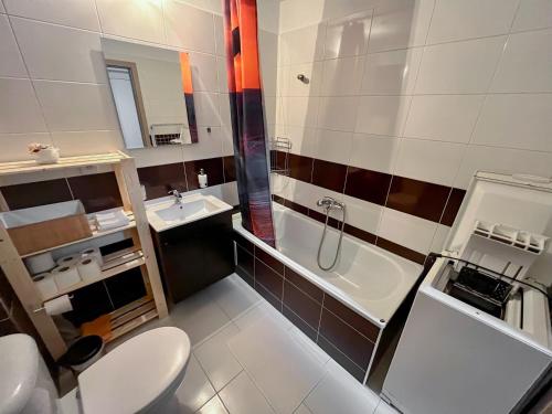 a bathroom with a toilet and a sink and a tub at Apartmán Podhorec - Liptovský Ján in Liptovský Ján