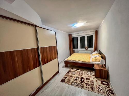 a small bedroom with a bed and a window at Apartmán Podhorec - Liptovský Ján in Liptovský Ján