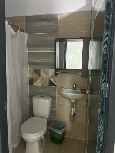 a small bathroom with a toilet and a sink at Hotel RIO Y SOL DORADO in La Dorada