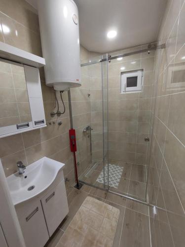 a bathroom with a shower and a sink at Stan na Dan Jovanovic in Valjevo