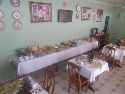 a table with plates of food on it at Hotel Solar do Caeté in Bragança