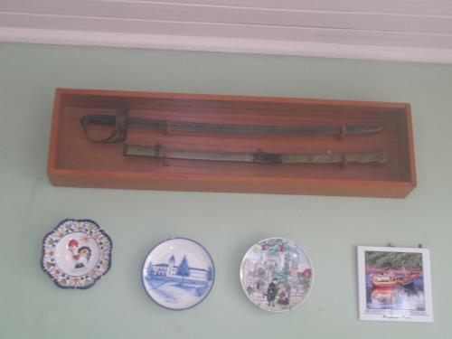 a collection of knives and utensils hanging on a wall at Hotel Solar do Caeté in Bragança