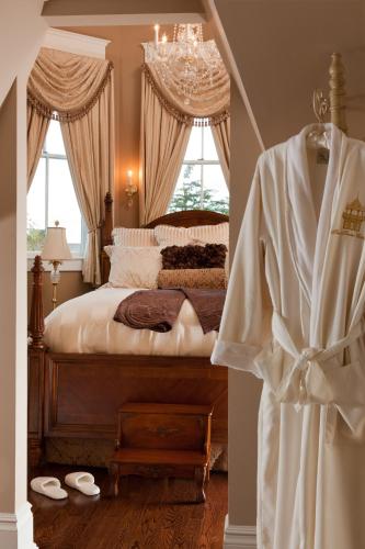 a bedroom with a bed with a chandelier at The Tower Cottage Bed and Breakfast in Point Pleasant Beach