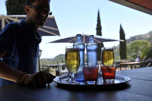 a man sitting at a table with four glasses of wine at L'Aixart Aiguablava Hotel in Begur