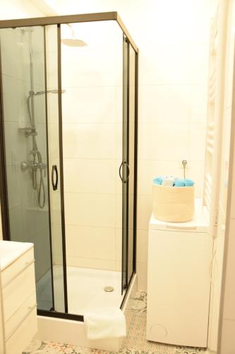 a shower with a glass door in a bathroom at Private rooms in the Old Town in Gdańsk