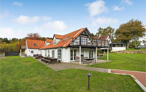 a white house with a red roof at 6 Bedroom Cozy Home In Gudhjem in Gudhjem