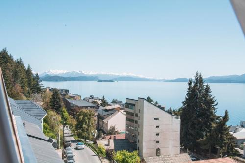 arial view of a city with a body of water at Tangoinn Hostel Downtown in San Carlos de Bariloche