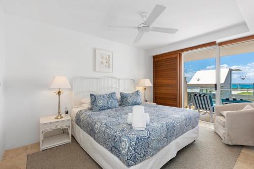 a bedroom with a bed with a view of the ocean at Crest Premium View Apartment 32 in Noosa Heads